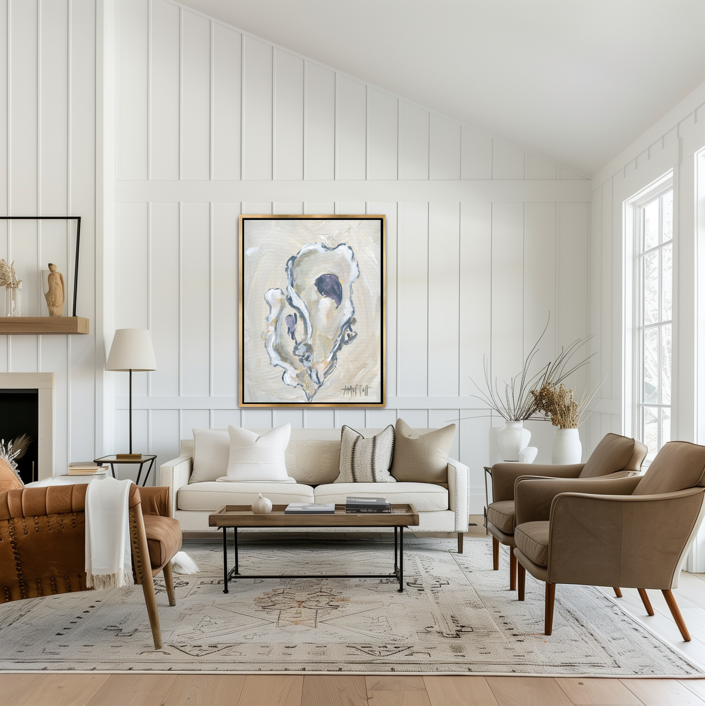 A textured beige oyster shell study in a gold frame, styled above a light oak console for a contemporary coastal aesthetic.