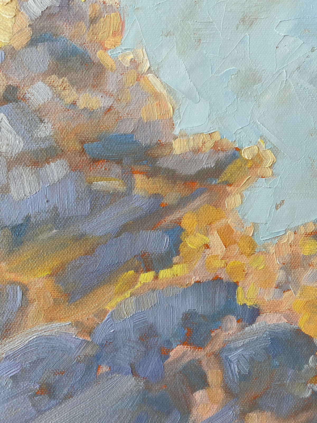 Up close view of an abstract impressionistic painting featuring textured brushstrokes in shades of blue, yellow, orange, and beige, with a pale blue sky-like area in the upper right.