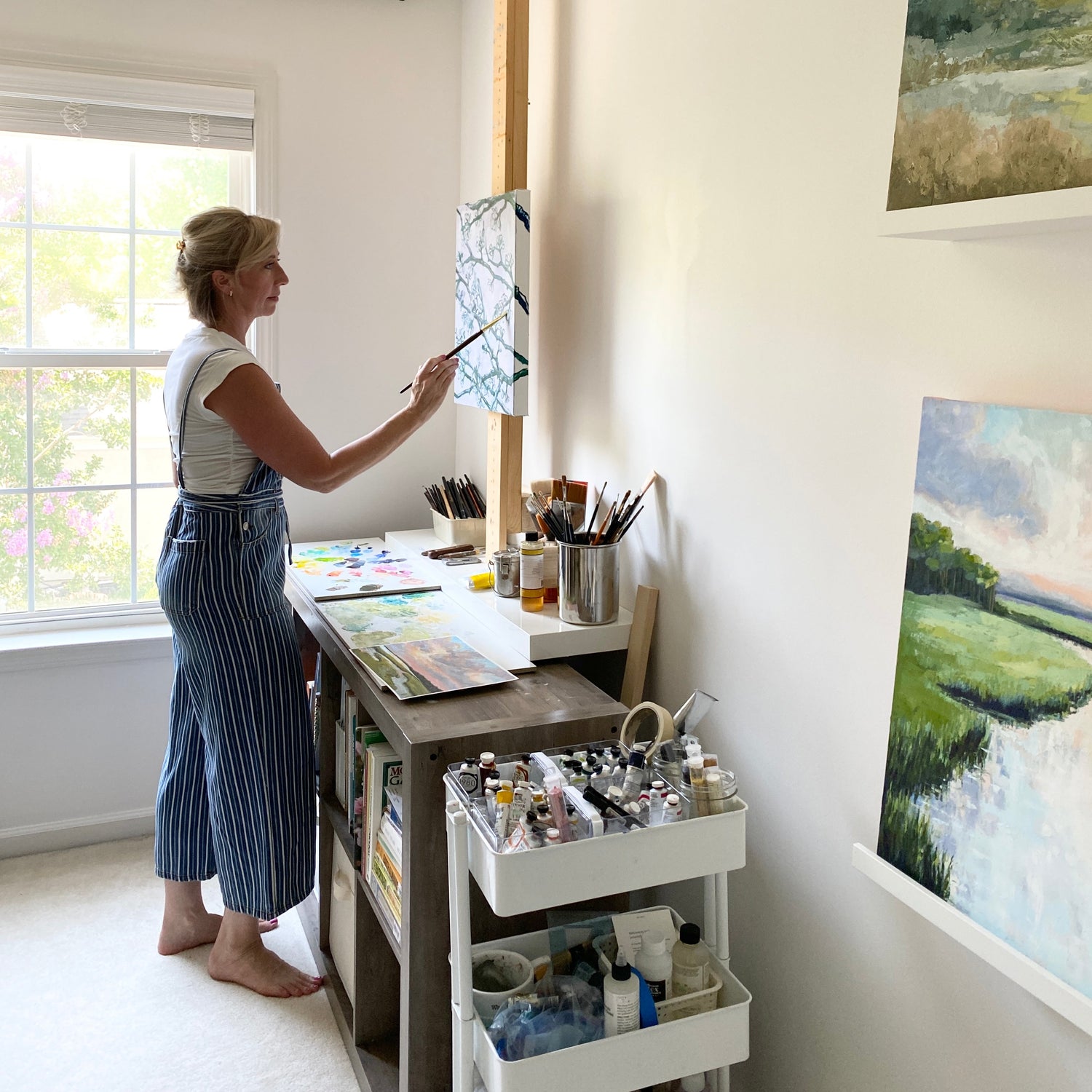 April Moffatt, at her easel, oil painting in her South Carolina studio