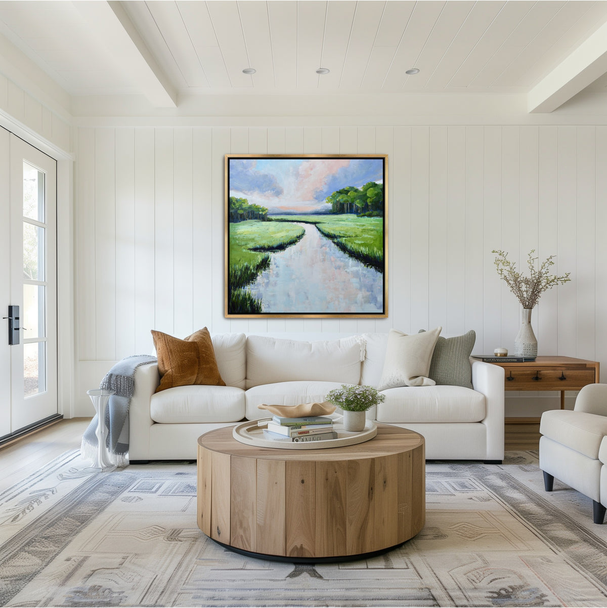 Large square Lowcountry evening art 'Periwinkle Reflection' styled in a gold frame within a coastal modern Savannah living room, showcasing deep navy and pink twilight tones.
