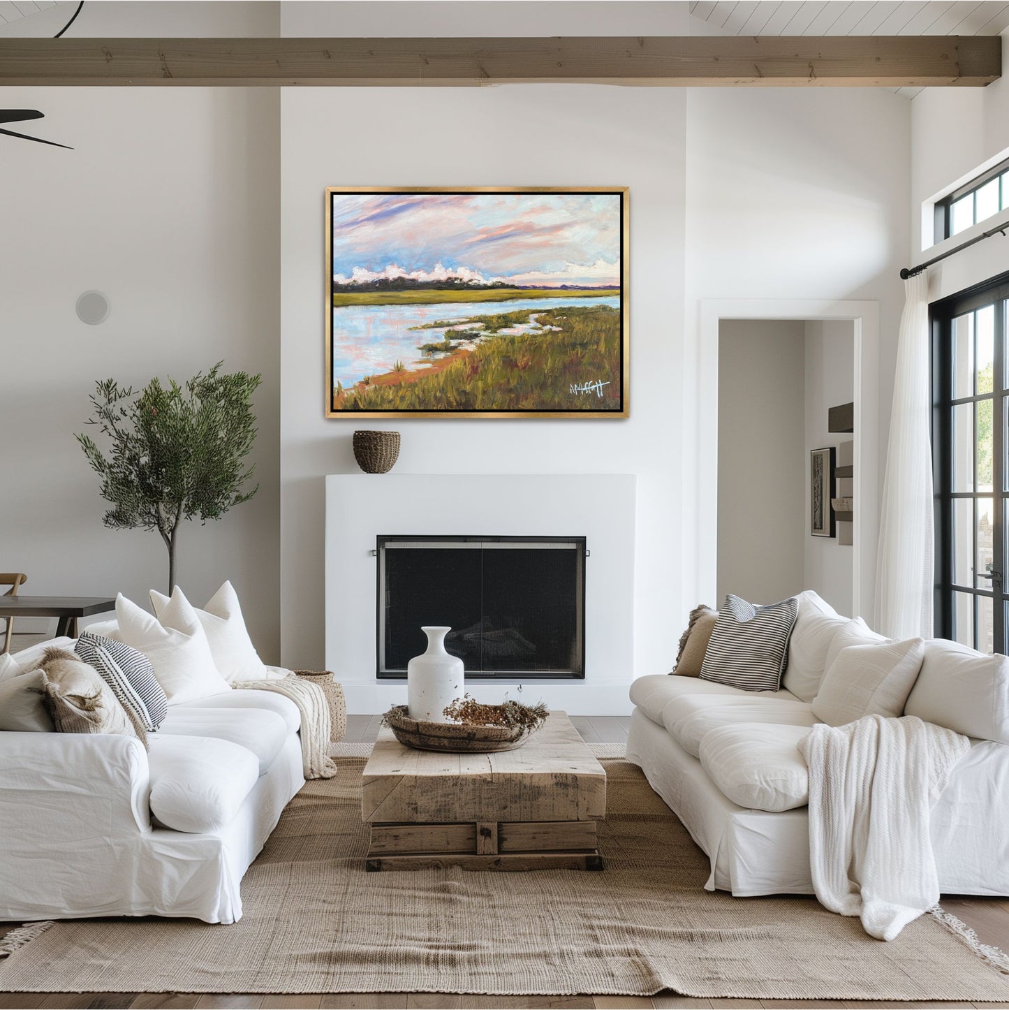 Modern square marsh art 'Skull Creek' with a soft pink and blue sky, styled in a gold frame as a focal point in a bright, light-filled Hilton Head Island vacation home.