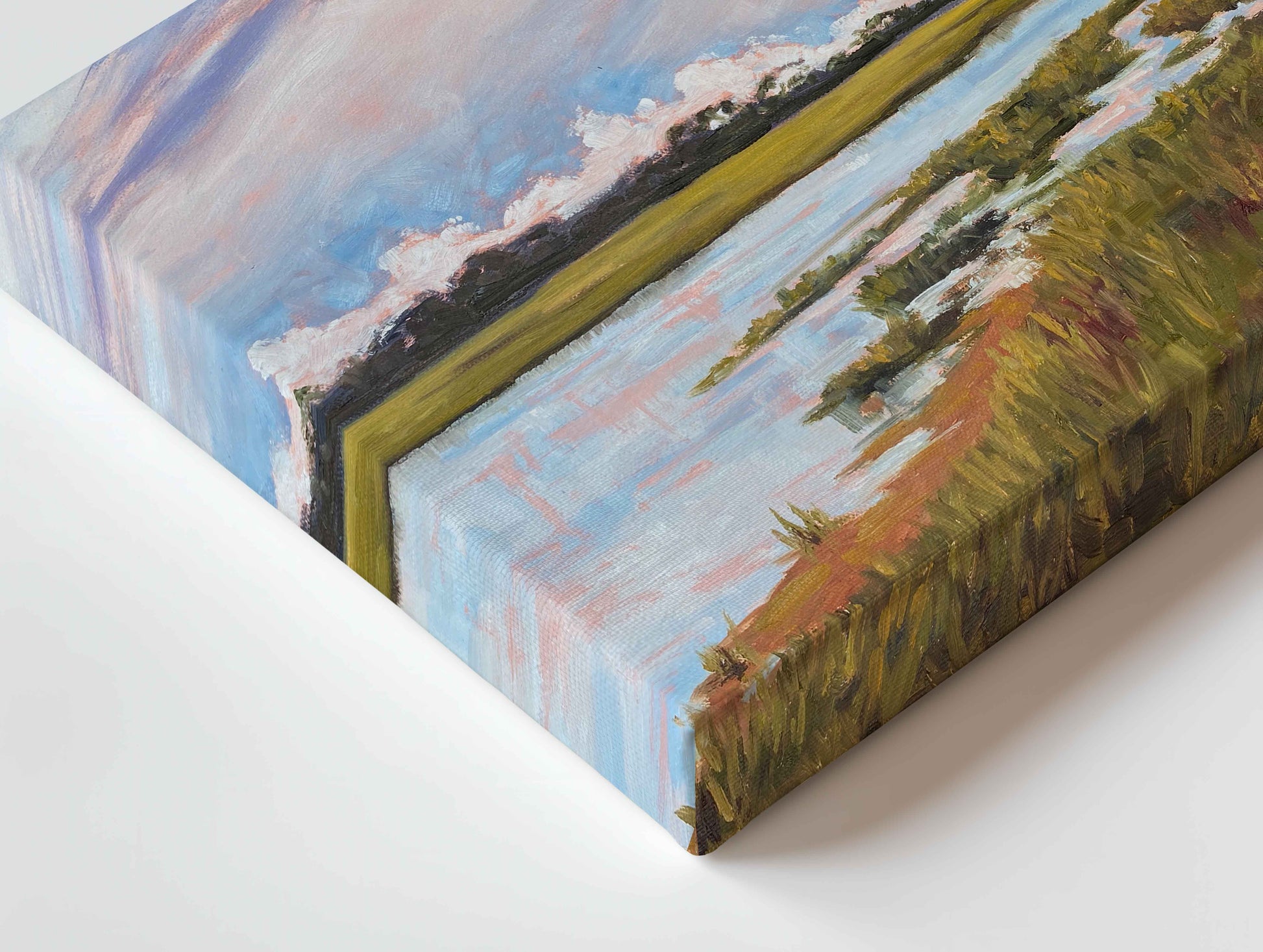 A close-up angled view of a canvas painting depicting a marsh landscape with blue sky, pale water, green and yellow fields, and brown grasses, shown against a white background.